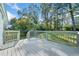 A view of the home's back deck overlooking a large yard with mature trees at 1467 Thompson Pl, Decatur, GA 30032