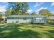 A large backyard with green grass and a wooden deck attached to the rear of the home at 1467 Thompson Pl, Decatur, GA 30032
