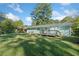 A view of the home's backyard, deck, and painted brick exterior under a blue sky at 1467 Thompson Pl, Decatur, GA 30032