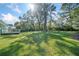 A very large backyard with green grass, bordered with mature shade trees at 1467 Thompson Pl, Decatur, GA 30032