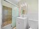 Bathroom featuring shower with glass door, sink, mirror and commode at 1467 Thompson Pl, Decatur, GA 30032