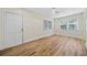 Spacious bedroom featuring hardwood floors, fan, and two windows at 1467 Thompson Pl, Decatur, GA 30032