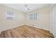 Bedroom featuring two windows, closet, overhead fan and new flooring at 1467 Thompson Pl, Decatur, GA 30032