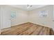 Bedroom featuring two windows, new flooring and overhead fan at 1467 Thompson Pl, Decatur, GA 30032