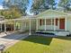 Charming home features a covered carport, green lawn, and brick facade at 1467 Thompson Pl, Decatur, GA 30032