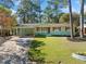 Charming single story home with green exterior, red shutters, and large front yard at 1467 Thompson Pl, Decatur, GA 30032
