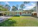 Charming one-story home featuring a carport, well-manicured lawn and a welcoming red front door at 1467 Thompson Pl, Decatur, GA 30032