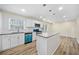 Bright kitchen with island, stainless steel appliances and stylish accents at 1467 Thompson Pl, Decatur, GA 30032