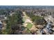 An aerial view of a golf course with houses nestled among the trees at 5679 Brookstone Nw Walk, Acworth, GA 30101