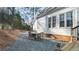 Lawn with mulched area and patio creating a relaxed setting in the backyard of this home at 5679 Brookstone Nw Walk, Acworth, GA 30101