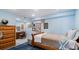 Blue basement bedroom with bed, desk, and hardwood dresser at 5679 Brookstone Nw Walk, Acworth, GA 30101