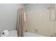 Close-up of the bathtub and shower with tiled walls and a shower curtain at 5679 Brookstone Nw Walk, Acworth, GA 30101