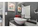 Elegant half-bathroom features a modern vessel sink, dark gray walls, and updated fixtures at 5679 Brookstone Nw Walk, Acworth, GA 30101