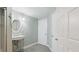 This bathroom has a pedestal sink, oval mirror, and tile flooring adjacent to a bedroom at 5679 Brookstone Nw Walk, Acworth, GA 30101