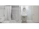 Bright bathroom features a tub/shower combination, oval mirror, and pedestal sink with chrome fixtures at 5679 Brookstone Nw Walk, Acworth, GA 30101