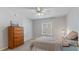 Comfortable bedroom featuring a ceiling fan, a double closet, and a wooden dresser, enhancing its cozy appeal at 5679 Brookstone Nw Walk, Acworth, GA 30101