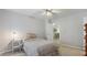 Bright bedroom showcasing a ceiling fan, carpet floors, a white nightstand, and a view of the adjacent sitting room at 5679 Brookstone Nw Walk, Acworth, GA 30101