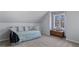 Cozy bedroom featuring a daybed with pillows, a wooden chest, carpet floors, and a large sunlit window at 5679 Brookstone Nw Walk, Acworth, GA 30101