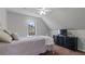 Inviting bedroom featuring a ceiling fan, carpet floors, a black dresser with a TV, and a large window at 5679 Brookstone Nw Walk, Acworth, GA 30101