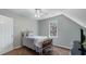 Comfortable bedroom features a ceiling fan, carpet floors, and a sunny window with a view of the outdoors at 5679 Brookstone Nw Walk, Acworth, GA 30101