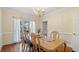 Bright dining area with a large window, wood table, and elegant decor for stylish entertaining at 5679 Brookstone Nw Walk, Acworth, GA 30101