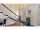 Elegant foyer featuring hardwood floors, a staircase with black accents, and a light-filled entryway at 5679 Brookstone Nw Walk, Acworth, GA 30101