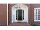 Close-up of a brick home's entryway featuring a black door with sidelights and a 'Welcome' sign at 5679 Brookstone Nw Walk, Acworth, GA 30101