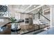 Bright kitchen featuring white cabinets, black countertops, stainless steel appliances, and hardwood floors at 5679 Brookstone Nw Walk, Acworth, GA 30101