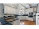 Bright kitchen featuring white cabinets, black countertops, stainless steel appliances, and hardwood floors at 5679 Brookstone Nw Walk, Acworth, GA 30101