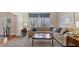 Cozy living room featuring a neutral sectional, a large window, and elegant accents at 5679 Brookstone Nw Walk, Acworth, GA 30101