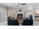 Inviting living room with cozy seating, a brick fireplace, and a ceiling fan for added comfort at 5679 Brookstone Nw Walk, Acworth, GA 30101