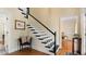 Stylish staircase with a combination of white and black accents, wooden floors, and natural light at 5679 Brookstone Nw Walk, Acworth, GA 30101