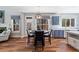 Dining area with backyard views, blue kitchen cabinets, and an open-concept layout to the living room at 133 Abbey Pointe Way, Suwanee, GA 30024