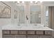 Well-lit bathroom featuring dual sinks, framed mirrors, and a glass-enclosed shower at 201 Lytham Se Dr, Mableton, GA 30126