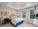 Bright bedroom with two windows, neutral carpet, and yellow decor at 201 Lytham Se Dr, Mableton, GA 30126