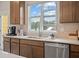 Kitchen featuring a large window, stainless steel dishwasher and ample counter space at 201 Lytham Se Dr, Mableton, GA 30126
