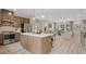 Open-concept kitchen featuring stainless steel appliances and island, seamlessly connected to the living room at 201 Lytham Se Dr, Mableton, GA 30126