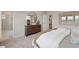 Relaxing bedroom showcases dresser with round mirror and ensuite bathroom at 201 Lytham Se Dr, Mableton, GA 30126
