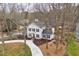 Charming two-story home featuring a well-manicured lawn and a curved driveway lined with mature trees at 2828 Saddlebrook Nw Way, Marietta, GA 30064