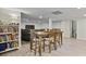 Open basement space featuring a dining table, a bookshelf, and a large gray couch with TV at 2828 Saddlebrook Nw Way, Marietta, GA 30064