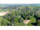Aerial view of wooded property with clearing, dirt roads, and meadows at 291 Folsom Glade Rd, Rydal, GA 30171