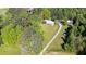 Aerial view of wooded property with home and outbuildings down a long driveway at 291 Folsom Glade Rd, Rydal, GA 30171