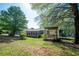 Backyard with partially covered deck and trampoline in a wooded setting at 291 Folsom Glade Rd, Rydal, GA 30171