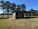 Open-air barn structure with sturdy wooden beams, nestled in a grassy, tree-lined field at 291 Folsom Glade Rd, Rydal, GA 30171