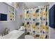 Hall bathroom with tub-shower combo, decorative curtain, and floral accents at 291 Folsom Glade Rd, Rydal, GA 30171