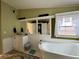 Bathroom with a soaking tub, vanity, updated fixtures, and a bright window to the exterior at 291 Folsom Glade Rd, Rydal, GA 30171