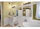 Bright bathroom with white wainscotting, a large vanity, and soaking tub at 291 Folsom Glade Rd, Rydal, GA 30171