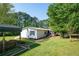 Single-story home with accessible ramp and screened porch, nestled in a lush, green yard at 291 Folsom Glade Rd, Rydal, GA 30171