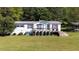 View of house with a deck and shutters in a well-maintained yard at 291 Folsom Glade Rd, Rydal, GA 30171