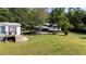 Exterior view of the house with a metal carport on a green lawn at 291 Folsom Glade Rd, Rydal, GA 30171